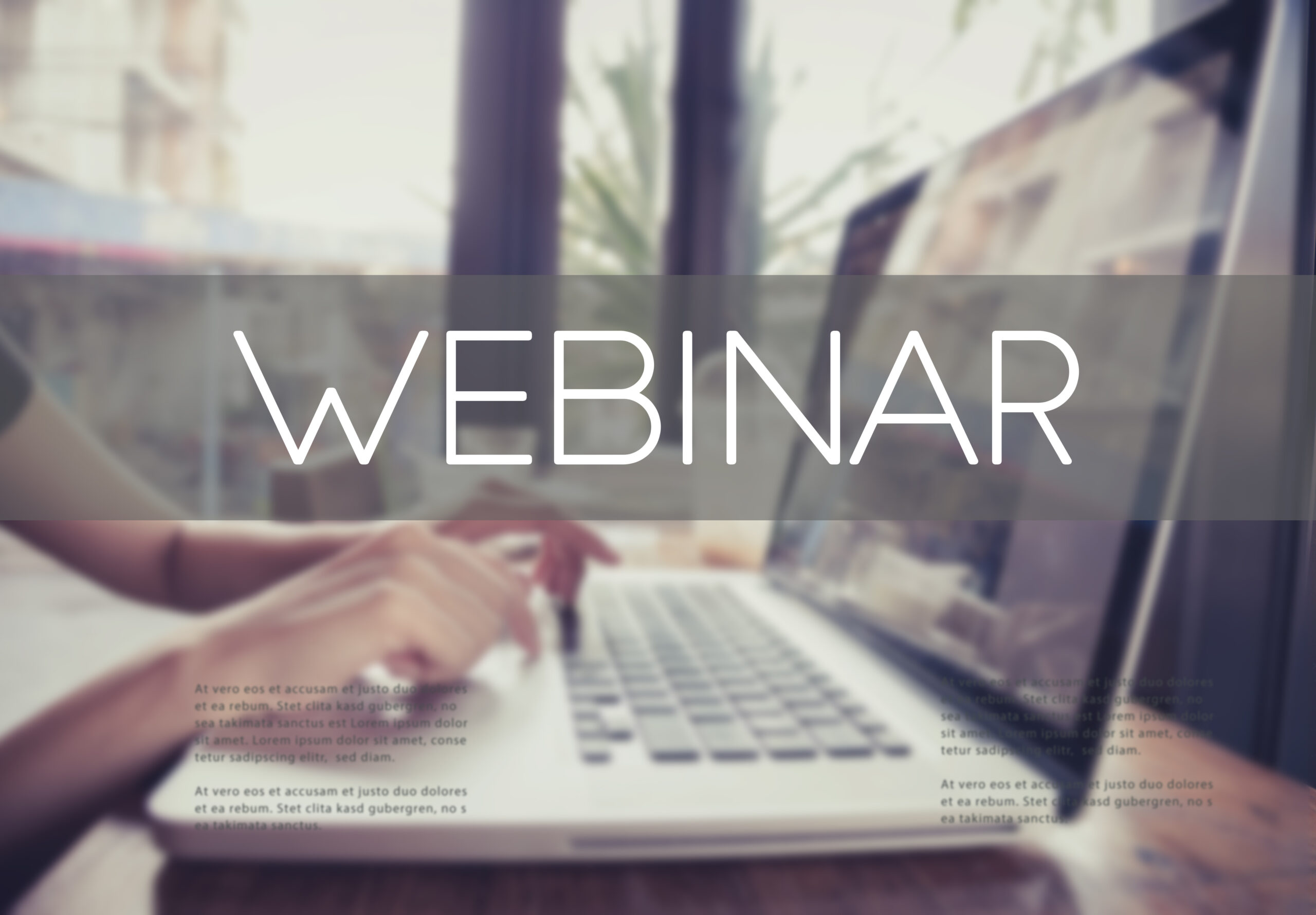 hands typing on keyboard with Webinar writing over laptop